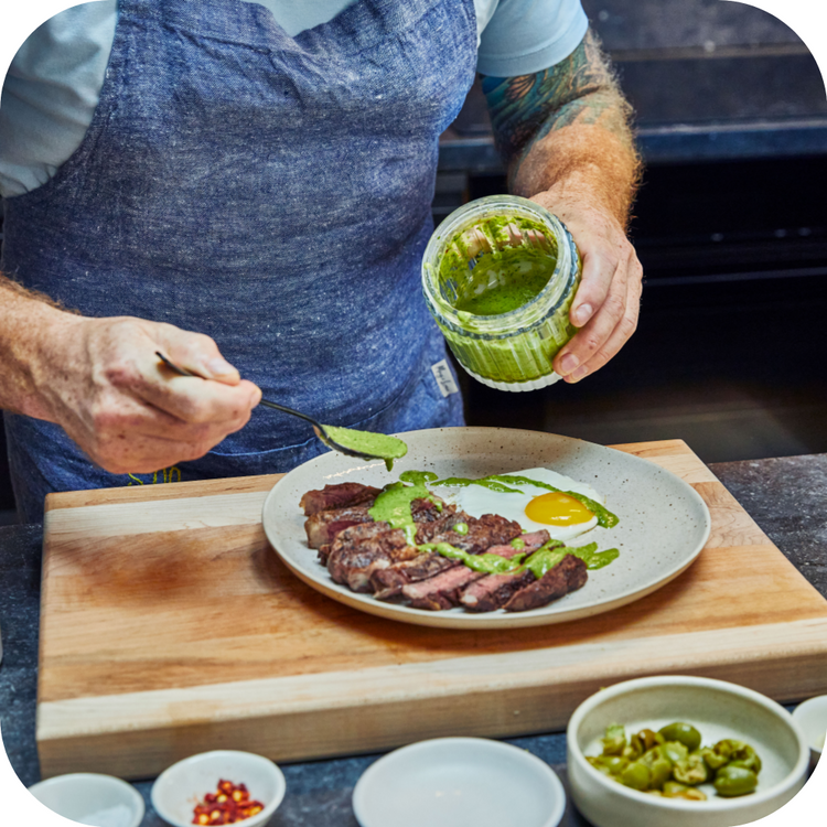 The chef decorates the dish with sauce